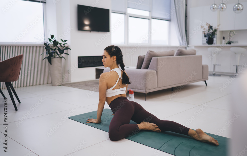 Slim woman lying on mat and practicing yoga Slim woman lying on mat and practicing yoga