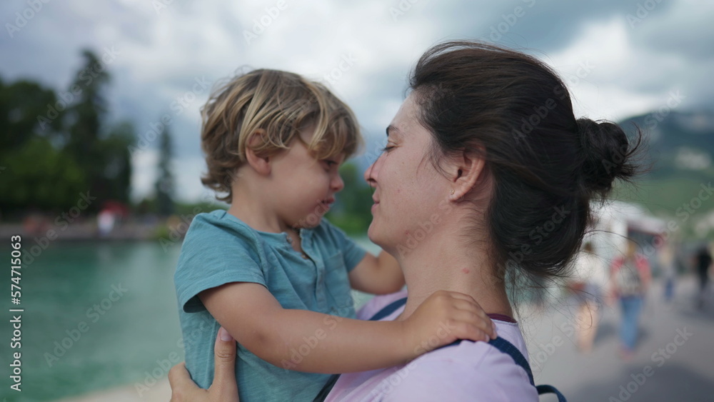 Cute mother and child bonding moment. Loving caring parent and child embrace. Lifestyle parenting hug and love outdoors Cute mother and child bonding moment. Loving caring parent and child embrace. Lifestyle parenting hug and love outdoors