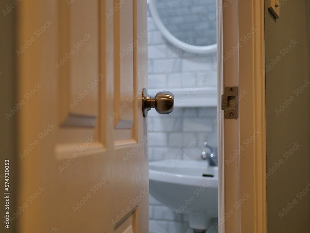 door in a hotel. The bathroom door opens to see the inside of the bathroom. Stock Photo Adobe