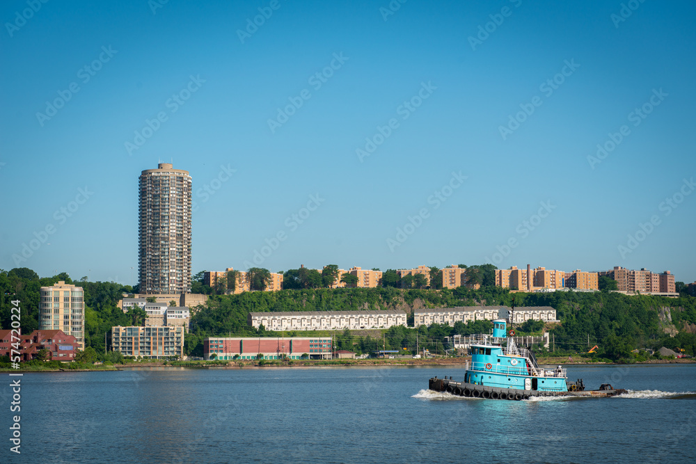 Tugboat going down the river and riverside residents