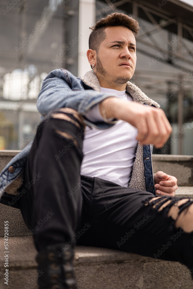 sitting young latin man with short hair and casual clothes, male model portrait with detail of face, sunny day and relaxed lifestyle sitting young latin man with short hair and casual clothes, male model portrait with detail of face, sunny day and relaxed lifestyle