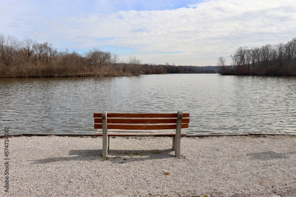 A view of the wood bench overlooking the lake.