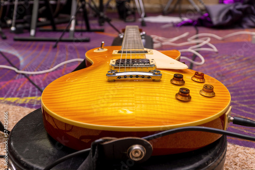 View of an electric guitar located on a hard case in the rehearsal room