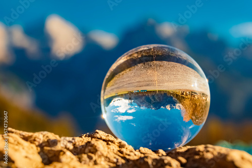 Crystal ball alpine landscape shot with the famous Loferer Steinberge mountains at St. Jakob in Haus, Tyrol, Austria