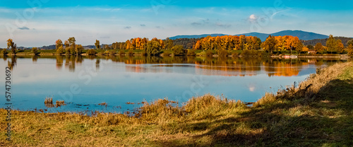 High resolution stitched autumn or indian summer panorama with reflections at Mettenufer, Danube, Bavaria, Germany