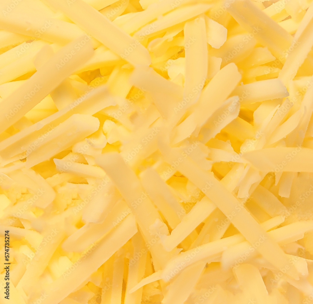 Grated cheese as a textured background. Gouda cheese wallpaper. Grated cheese as a textured background. Gouda cheese wallpaper.