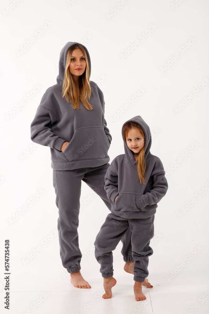 Sporty mom and her little daughter in thermal clothes. Sporty mom and her little daughter in thermal clothes.