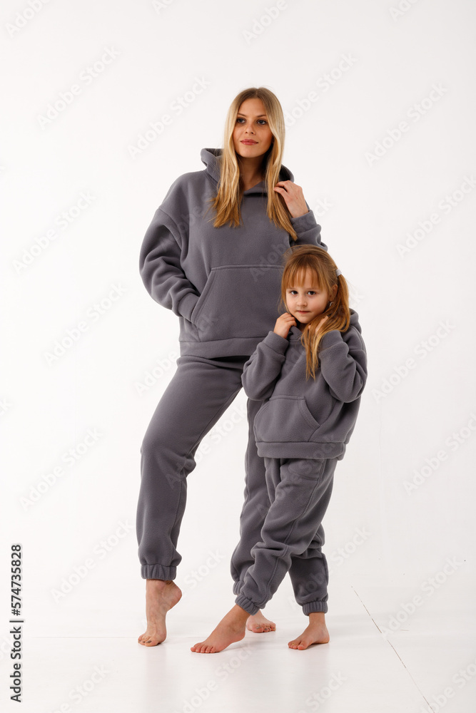 Sporty mom and her little daughter in thermal clothes. Sporty mom and her little daughter in thermal clothes.