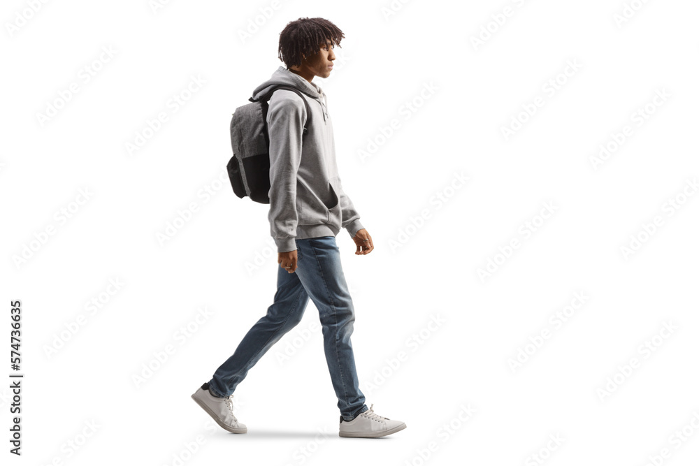 Full length profile shot of an african american male student walking Full length profile shot of an african american male student walking