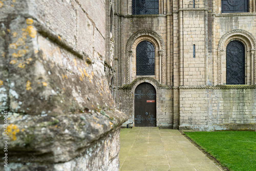 Distant focus of a wooden door, with entry to the cathedral crypt. The red sign on the door informs visitors to use another door.