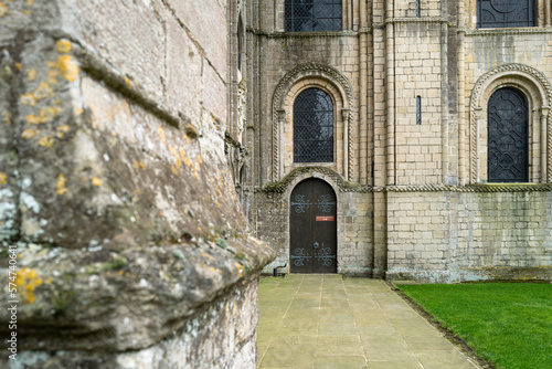 Distant focus of a wooden door  with entry to the cathedral crypt. The red sign on the door informs visitors to use another door.