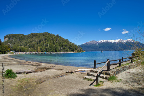 View of Lake with mountains in the background and pier. Brava Bay in Villa La Angostura. Patagonia Argentina