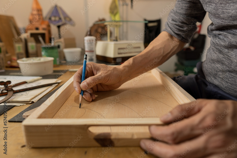 gentleman drawing his ideas by hand in his workshop