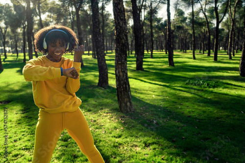 A girl in a yellow tracksuit checking the times she has achieved.