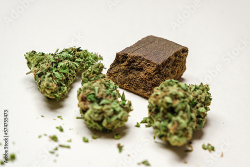 High quality marijuana, cannabis, weed buds and a piece of dry hashish on a white background