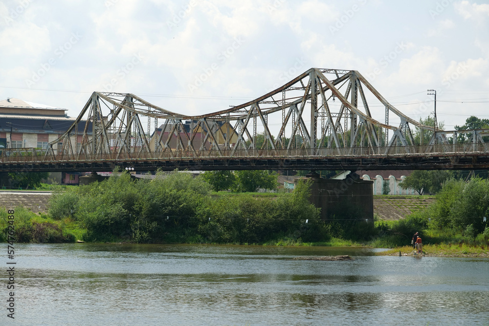 Fototapeta premium Old metal bridge across Dniester river in the city of Halych, western Ukraine