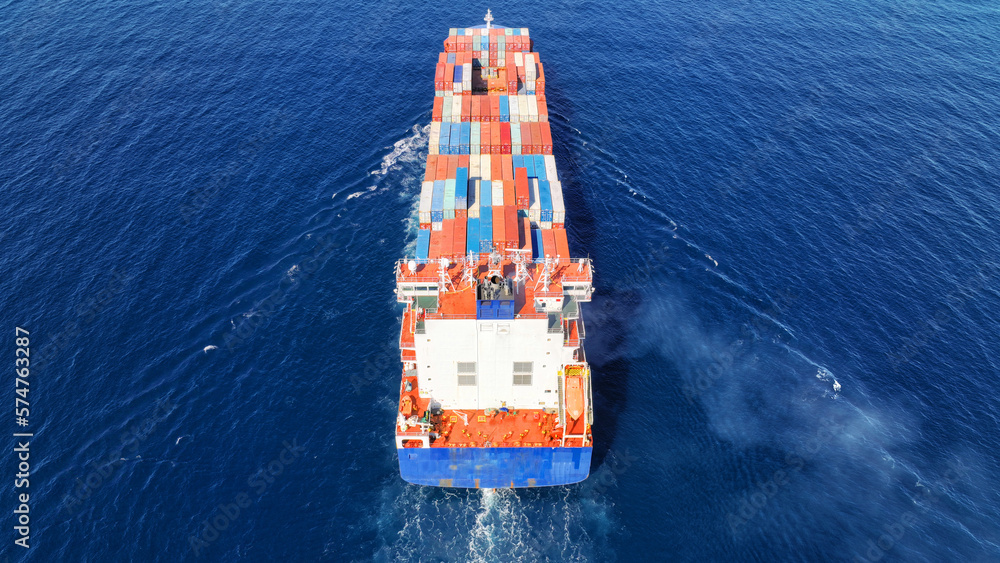 Aerial drone photo of truck size container ship cruising deep blue Mediterranean sea