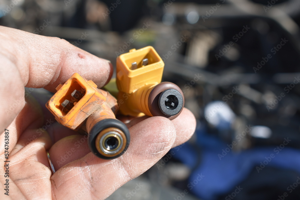 Replacing Old Fuel Injectors, Female Hand Holding Car Parts