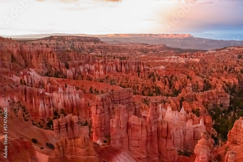 Panoramic morning sunrise view on sandstone rock formations on Navajo Rim hiking trail in Bryce Canyon National Park, Utah, UT, USA. Golden hour colored hoodoo rocks in unique natural amphitheatre © Chris