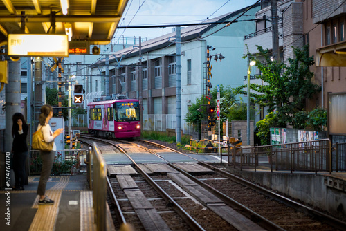 Tokyo Shitamachi trolly train (Toden) station platform and woman waiting