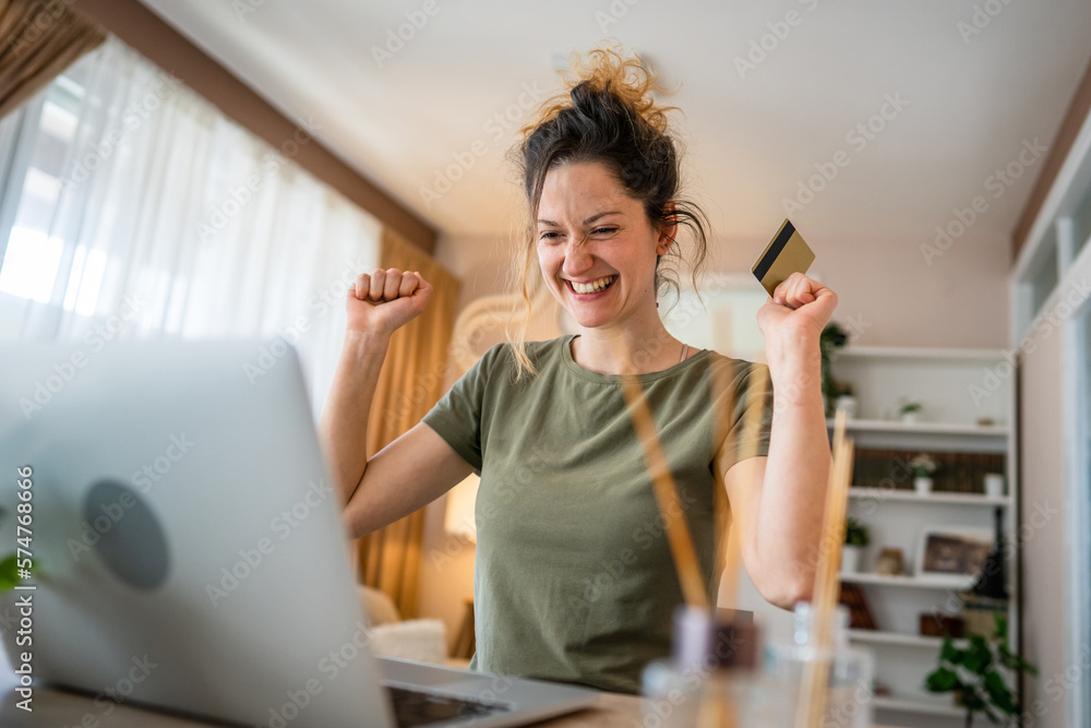happy woman online shopping use credit card laptop computer at home happy woman online shopping use credit card laptop computer at home