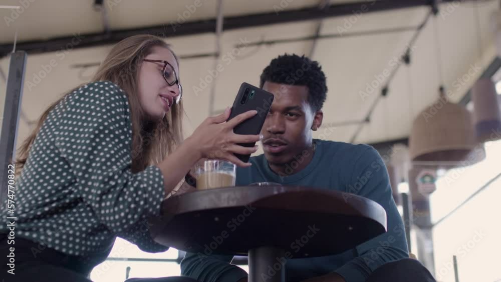 Friends in a cafe bar. Multiethnic business colleagues having a meeting in a restaurant. Couple enjoying free time.. Friends in a cafe bar. Multiethnic business colleagues having a meeting in a restaurant. Couple enjoying free time..