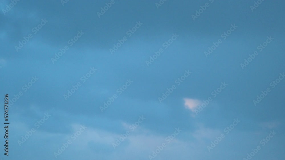 This time-lapse video shows the movement of white clouds on a blue sky, with different shapes and patterns emerging throughout the day. This time-lapse video shows the movement of white clouds on a blue sky, with different shapes and patterns emerging throughout the day.