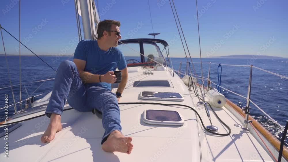 Man relaxing on sailing yacht boat ocean sunny day, travel adventure lifestyle Man relaxing on sailing yacht boat ocean sunny day, travel adventure lifestyle