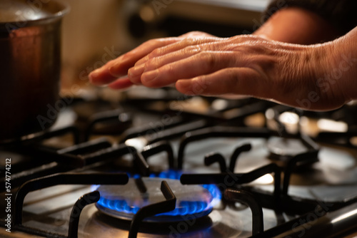 Hand heating over a gas stove