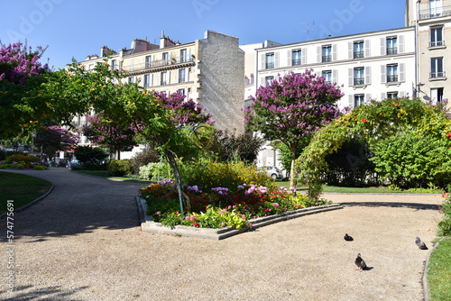 Fototapeta Naklejka Na Ścianę i Meble -  Park and Traditional Parisian Apartment Buildings at Place d’Italie in Paris, France