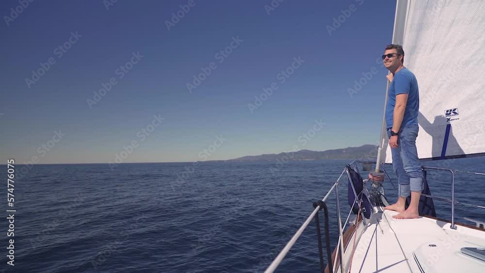 Man on sailing yacht boat ocean on a sunny day, travel adventure lifestyle Man on sailing yacht boat ocean on a sunny day, travel adventure lifestyle