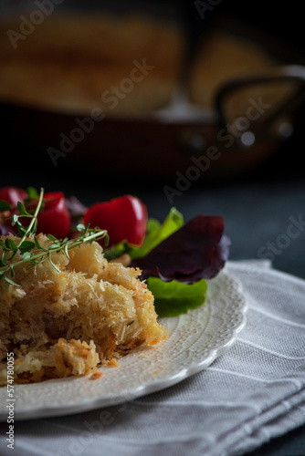 Salt cod brandade garnished with thyme. Salt cod is blended with potatoes, milk, garlic, and olive oil, then baked in a casserole or au gratin pan.