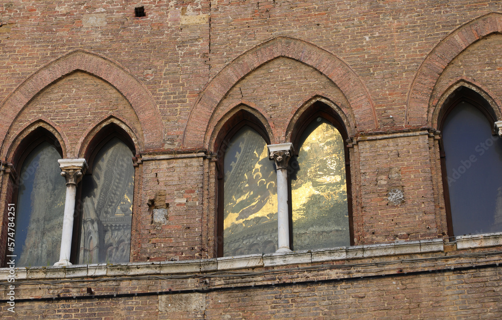 reflections in the old Windows called Bifore in the old medieval Italian palace