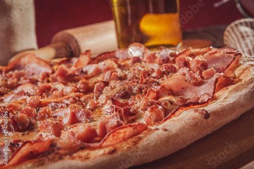 Brazilian pizza with tomato sause, mozzarella, pork loin, bacon and oregano (Pizza de lombinho e bacon) - Closeup.