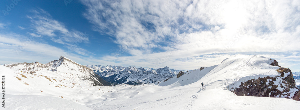 Man is snowshoe hiking in amazing alpine winter mountains landscape. Ifen, Haehlekopf, Vorarlberg, Austria.
