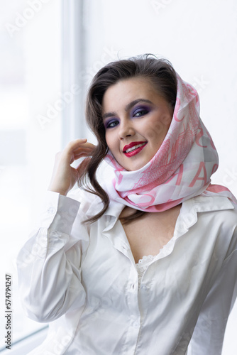 PPortrait of attractive beautiful fashionable young woman dressed in the style of 1980s, with bright fancy make up, pink scarf, glasses. 80s inspiration and vibes photo