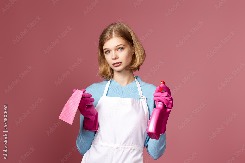 frowning woman cleaner apron with cleaning rag and detergent sprayer frowning woman cleaner apron with cleaning rag and detergent sprayer
