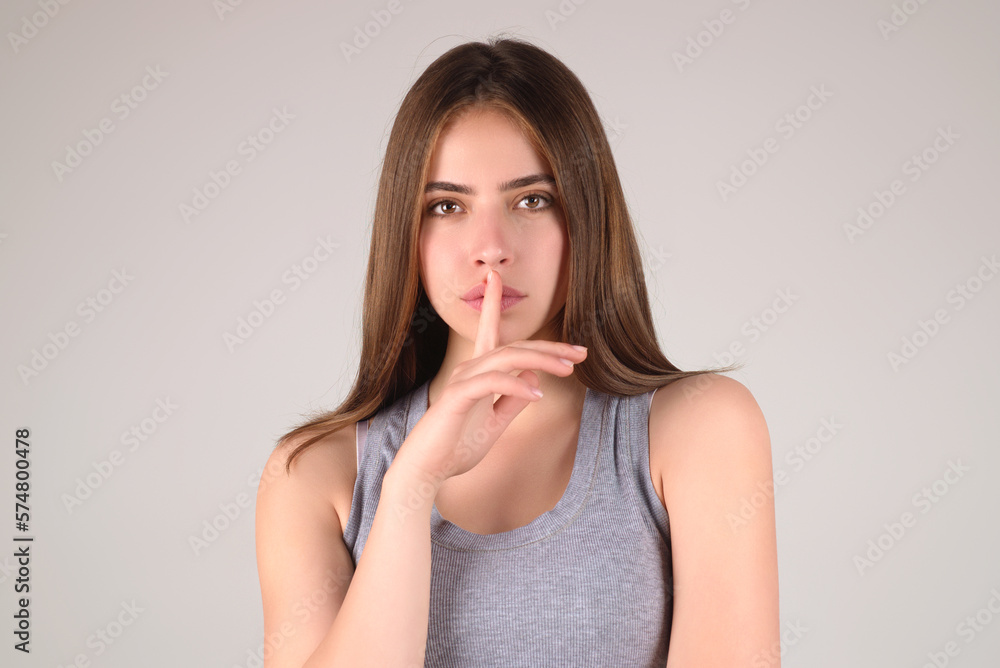 Say secret hush be quiet with finger on lips. Shhh gesture isolated on studio background portrait. Girl showing hush. Woman say secret hush be quiet with finger on lips, shhh gesture. Say secret hush be quiet with finger on lips. Shhh gesture isolated on studio background portrait. Girl showing hush. Woman say secret hush be quiet with finger on lips, shhh gesture.