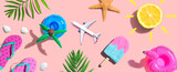 Summer concept with a airplane, a popsicle, flip flops and lemon sunshine - flat lay