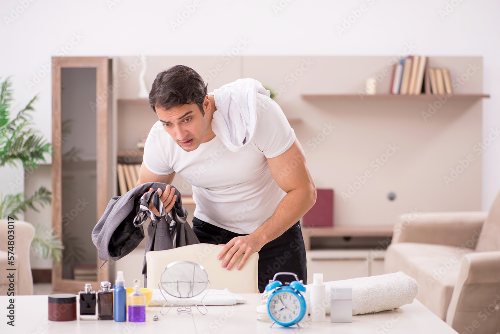 Young male employee getting up late at home Young male employee getting up late at home