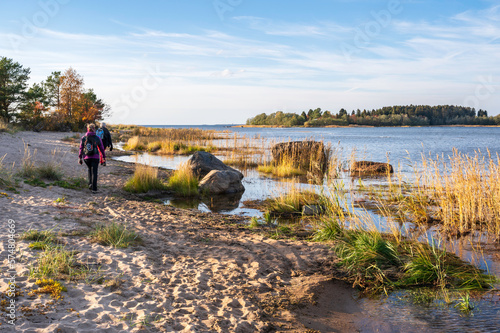 People walking on a beach in autumn, Nykarleby/Uusikaarlepyy, Finland.