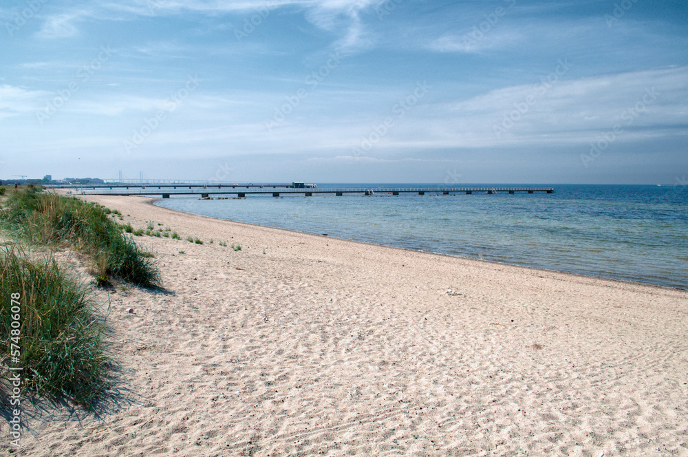 Sandy beach with sea coast and pier in Malmo, Sweden Sandy beach with sea coast and pier in Malmo, Sweden