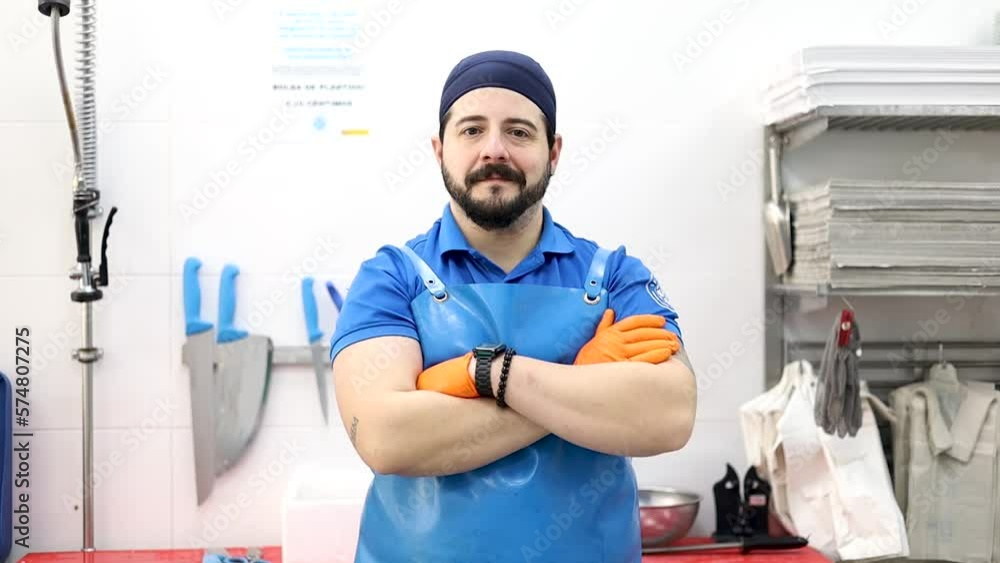 A middle-aged fishmonger poses with his arms crossed while looking at the camera, selling food, small and medium-sized business. A middle-aged fishmonger poses with his arms crossed while looking at the camera, selling food, small and medium-sized business.