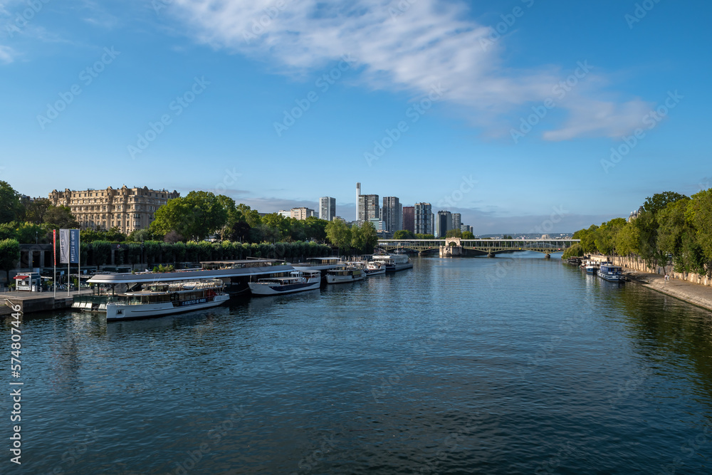 River Seine In Paris With Promenade, Anchored And Modern Office Buildings