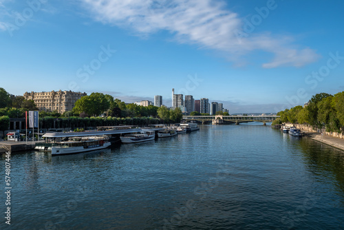 River Seine In Paris With Promenade, Anchored And Modern Office Buildings