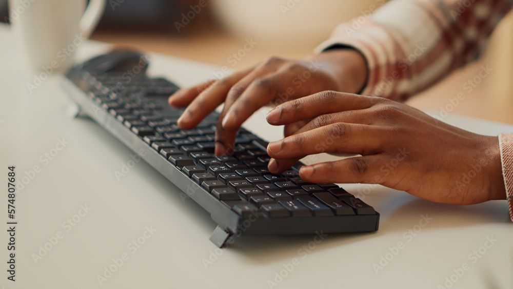 Young adult typing data to create report on computer, using keyboard to send professional email. Freelancer analyzing marketing sales and doing accounting job remotely at home. Close up. Young adult typing data to create report on computer, using keyboard to send professional email. Freelancer analyzing marketing sales and doing accounting job remotely at home. Close up.