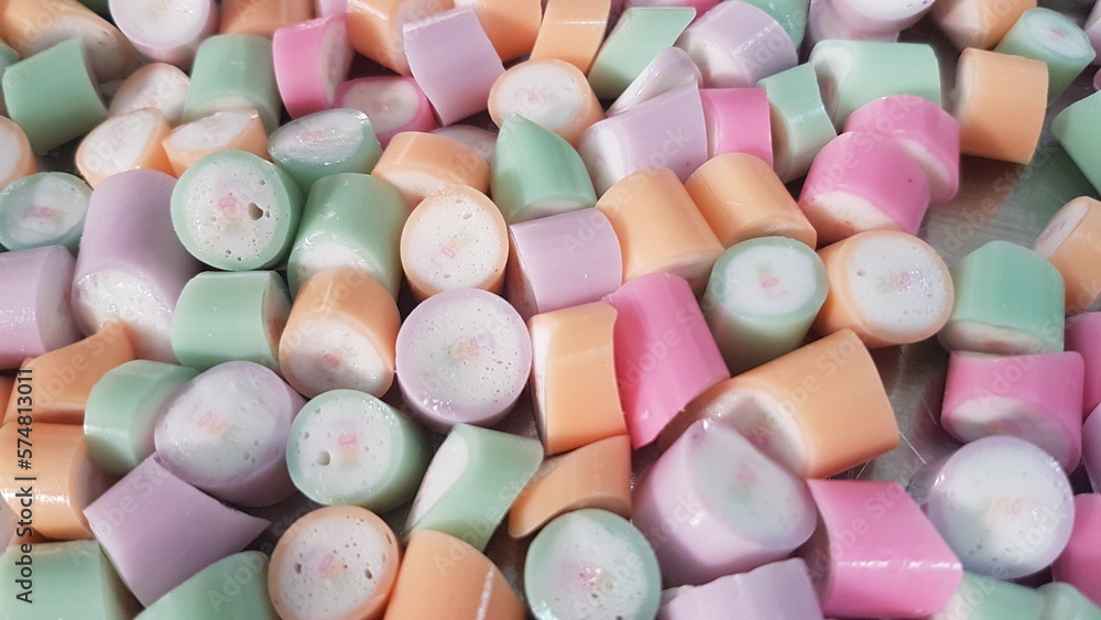 handmade caramel lollipops in different colors, pastel texture handmade caramel lollipops in different colors, pastel texture