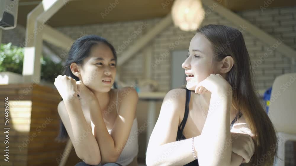 Portrait of young LGBTQ Asian and caucasian women couple or friends talking together. Multi ethnic people. Relaxed lifestyle. Love in relationship. Portrait of young LGBTQ Asian and caucasian women couple or friends talking together. Multi ethnic people. Relaxed lifestyle. Love in relationship.