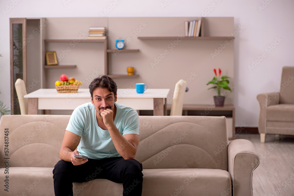 Young man watching tv at home Young man watching tv at home