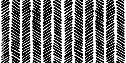Seamless whimsical abstract hand drawn striped herringbone pattern. Monochrome bold black paint strokes chevron motif texture on white background in a trendy painterly scribble doodle line art style.
